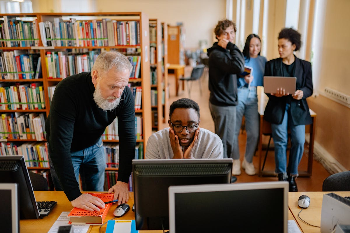 Students and a mentor looking at a computer monitor